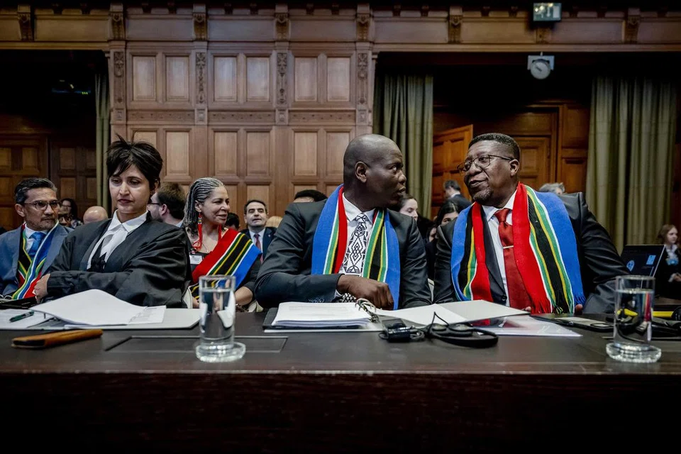 BAWA ISRAEL KE ICJ: Menteri Kehakiman Afrika Selatan, Encik Ronald Lamola (tengah) dan Duta Besar Afrika Selatan ke Belanda, Encik Vusimuzi Madonsela (kanan), di Mahkamah Keadilan Antarabangsa (ICJ), sebelum perbicaraan kes pembunuhan beramai-ramai terhadap Israel di The Hague, Belanda, pada 11 Januari.