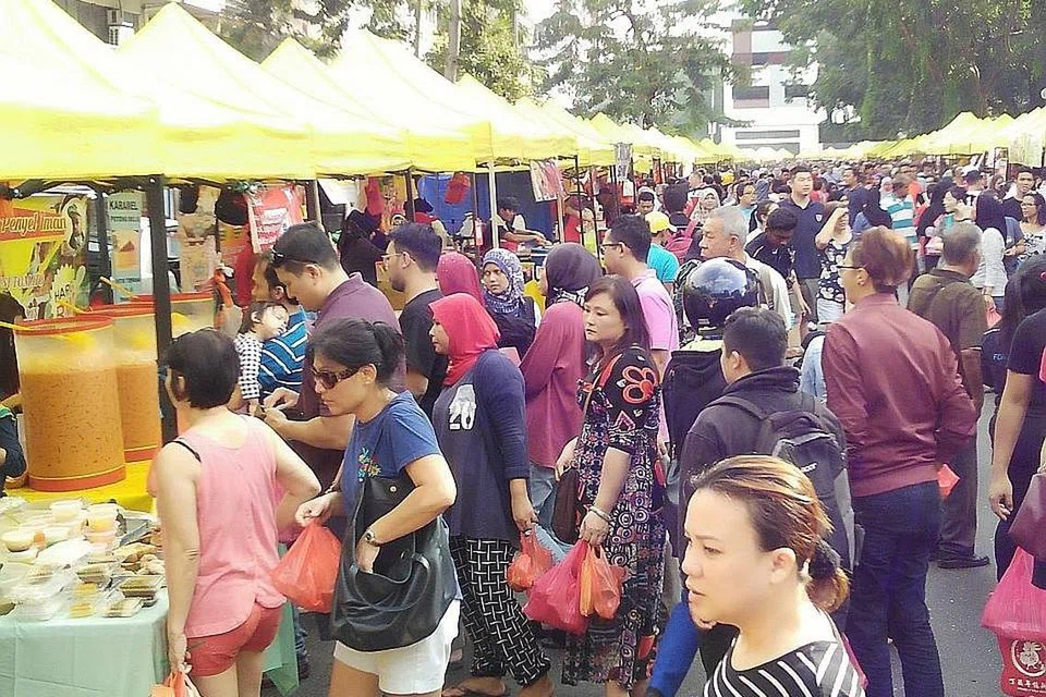 HIDUP HARMONI: Pengunjung daripada pelbagai kaum turut mengunjungi bazar Ramadan di Taman Tun Dr Ismail dekat Damansara menjelang Hari Raya bagi menikmati pelbagai juadah berbuka puasa. - Foto BM oleh SAINI SALLEH