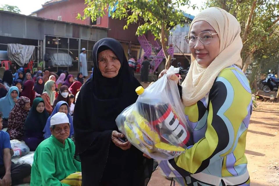 Penyanyi Eka Mairina ketika mengagihkan habuan makanan kepada penduduk Islam di wilayah Kampong Cham di Kemboja.