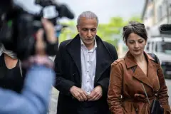 DIDAKWA: Encik Tariq Ramadan dilihat di luar mahkamah Swiss bersama peguamnya. - Foto AFP