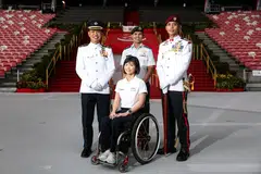 *EMBARGO UNTIL 3PM* (From left) Military Expert 6 Caleb Chia, 43, NDP parade commander, Colonel Anthony Lau, 45, NDP Parade and Ceremony Committee chairman, Yap Qian Yin, 35, a civilian contingent participant from the Singapore Disability Sports Council, and Master Warrant Officer Low Kay Kee, 44,  parade regimental sergeant major, during the Parade & Ceremony media event at National Stadium on June 25, 2026. ST PHOTO: BRIAN TEO