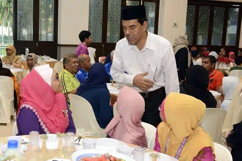 HABUAN RAMADAN: Ketua Eksekutif Majlius Ugama Islam Singapura (Muis), Haji Abdul Razak Maricar, berbual dengan penerima habuan Ramadan zakat. Habuan Ramadan antara pelbagai bantuan yang diberikan kepada golongan memerlukan daripada asnaf fakir dan miskin bagi membantu mereka dalam persiapan Hari Raya Aidilfitri. - Foto MUIS 