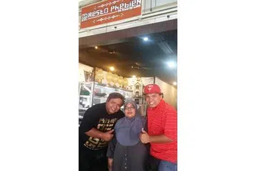 MASAKAN BAWEAN ASLI: Cik Rusni diapit dua anaknya, Encik Mohamad Zuraini Hamsani (kiri) dan Encik Mohamad Sarwani (kanan) yang membuka restoran masakan Bawean di Changi Village Road. - Foto-foto KULINARY AFFAIRS