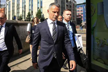 PERTAHAN NAMA: Ryan Giggs (depan) tiba di mahkamah kelmarin bersama pasukan peguamnya bagi perbicaraan atas dakwaan bertindak ganas terhadap bekas temanitanya. - Foto AFP