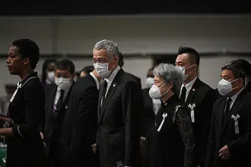 BERI PENGHORMATAN: Perdana Menteri, Encik Lee Hsien Loong dan isteri, Cik Ho Ching tiba di acara persemadian negara Encik Shinzo Abe. - Foto-foto REUTERS