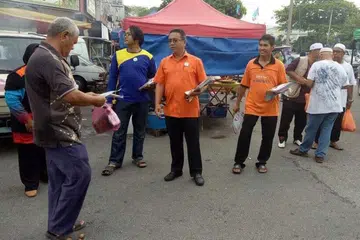YAKIN DAPAT TAWAN MELAKA: Pengerusi Harapan Melaka, Haji Adly Zahari (tengah) mengedar-edarkan risalah semasa berkempen di Melaka. - Foto FACEBOOK ADLY ZAHARI