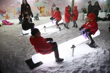 KEAJAIBAN MUSIM SEJUK: Naik jungkat-jungkit di tengah-tengah salji atau turun gelongsor sepanjang lima meter di Candy Snow House dan Candy Carnival di Terminal 3 Lapangan Terbang Changi.