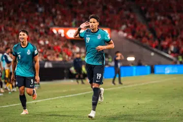 Penyerang Singa, Ilhan Fandi (kanan) meraikan gol kemenangan beliau menentang Hong Kong dalam perlawanan kelayakan Piala Asia pada 18 November di Stadium Kai Tak. Jaringan beliau menghantar Singa ke Piala Asia Arab Saudi 2027.