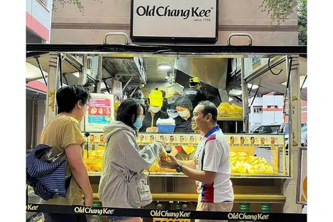 AGIH SARAPAN PERCUMA: Anggota Parlimen bagi GRC Choa Chu Kang, Encik Zhulkarnain Abdul Rahim (kanan), mengagihkan set sarapan percuma dari trak makanan Old Chang Kee kepada penduduk di kawasan itu pada Ahad lalu. - FOTO FACEBOOK ZHULKARNAIN ABDUL RAHIM