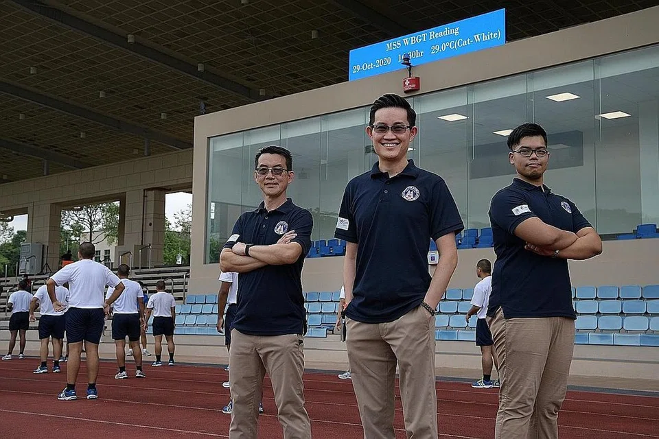 CIPTA KAEDAH BARU: Cabang Keselamatan dan Audit Latihan (TSAB), Akademi Home Team yang dianggotai (dari kiri) Penolong Eksekutif Kanan Encik Chua Ban Joo; Timbalan Pengarah, Encik Lin Zhiyong Brian; dan Eksekutif Kanan, Encik Aliff Hurairah, telah mencipta panel pemantau WBGT (atas, skrin biru) yang memudahkan proses memantau suhu sebelum latihan dimulakan. - Foto BH oleh NG SOR LUAN