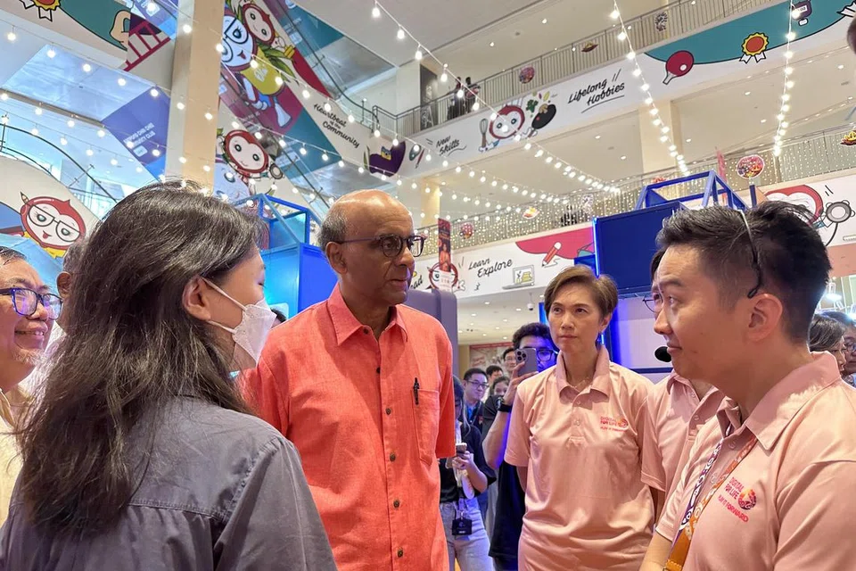 GALAK WARGA DAKAP DIGITAL: Presiden Tharman Shanmugaratnam (tengah) yang juga penaung gerakan Digital Sepanjang Hayat bersama Menteri Perhubungan dan Penerangan, Cik Josephine Teo (dua dari kanan) sertai penduduk bagi Festival Digital Sepanjang Hayat yang diadakan di Heartbeat@Bedok pada Sabtu.
