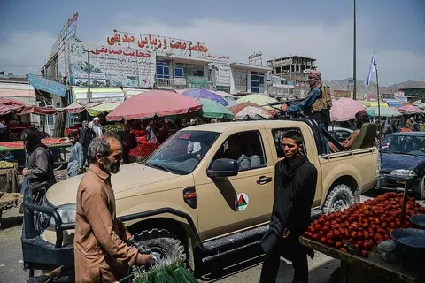 MASALAH MAKANAN: Tentera Taleban berada di atas trak yang bergerak di sekitar pasar yang dikunjungi penduduk Aghanistan di Kote Sangi, Kabul. - Foto AFP