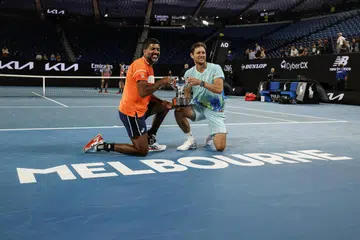 Rohan Bopanna (kiri) dan Matthew Ebden bersama piala yang dimenangi selepas menjuarai tenis acara regu lelaki Terbuka Australia dengan menewaskan Simone Bolelli dan Andrea Vavassori pada 27 Januari.