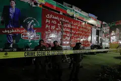 PELURU KENA KAKI: Gambar atas ialah kenderaan yang dinaiki Encik Imran, sebuah kontena yang dipasang di atas sebuah trak dengan pentas di atas, yang telah dikepung polis sedang mereka meneruskan siasatan. - Foto REUTERS