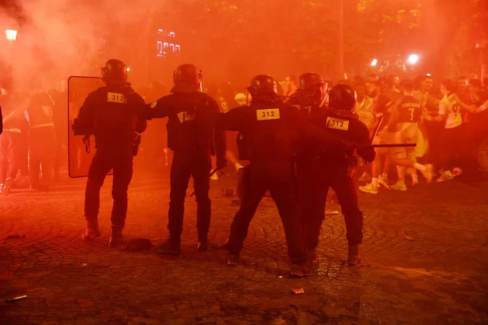 Polis melindungi diri mereka daripada peminat di jalan Champs Elysees selepas Paris St Germain (PSG) memenangi Liga Juara-Juara. Terdapat insiden ganas yang berlaku sehingga  mengorbankan dua jiwa selain sekitar 30 anggota polis dan beberapa anggota bomba cedera.