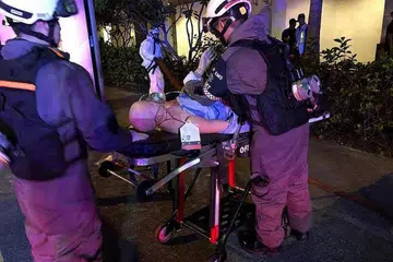 PERKEMAS PROSEDUR: Beberapa pegawai SCDF mengusung 'mangsa' dalam latihan kecemasan di Compass One semalam. - Foto FACEBOOK SCDF