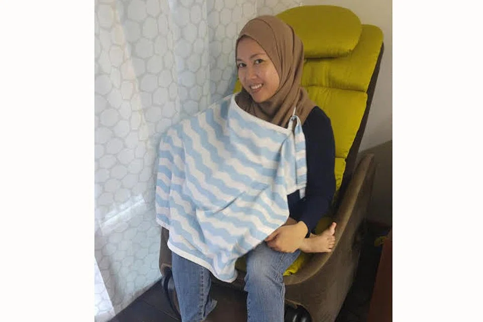 SELESA MENYUSUKAN BAYI DI TEMPAT AWAM: Cik Norliza Ibrahim menggunakan kain bagi menutup bayi dan dadanya semasa menyusukan anaknya. - Foto ihsan NORLIZA IBRAHIM