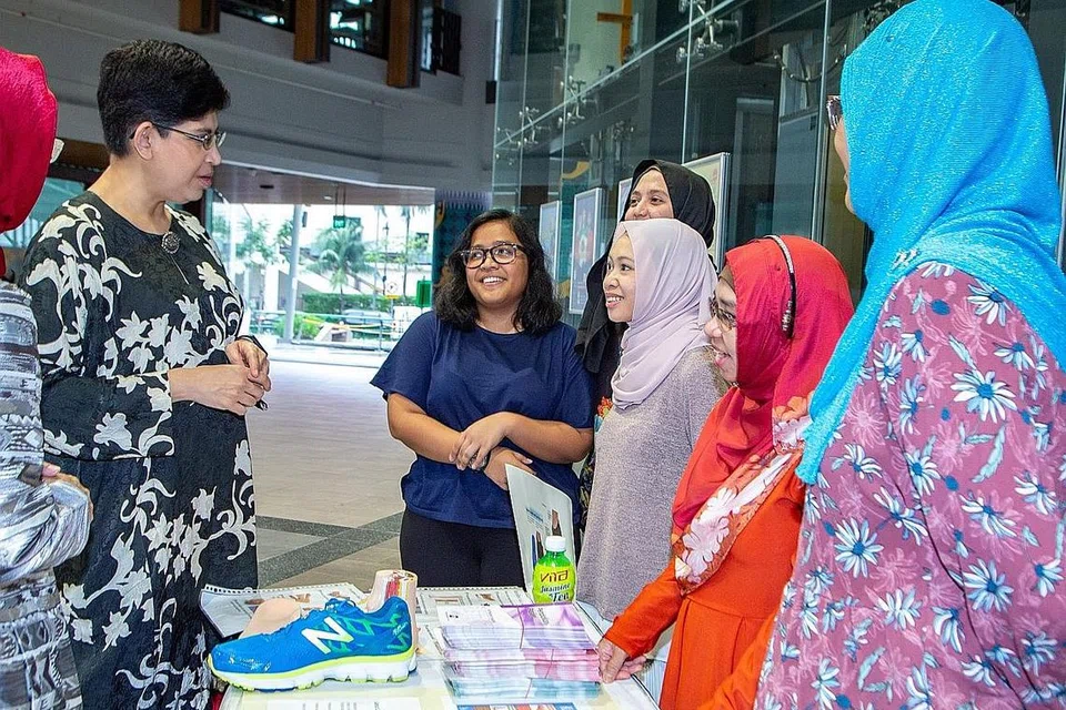 BERAMAH MESRA: Anggota Parlimen GRC Marine Parade, Dr Fatimah Lateef (kiri), menemui pengendali reruai dalam forum MHPA. - Foto BH oleh ZALEHA ABDUL KADER