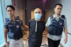 Elvin John Baptist, 27 tahun (tengah), warga Singapura, didakwa memuat naik video dirinya di media sosial yang menunjukkan beliau mengeluarkan kata-kata menghina dan kesat terhadap golongan Muslim di Singapura.