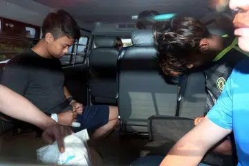 Muhammad Khalid Kamarudin (kiri) dan Muhammad Hisham Hassan didakwa di mahkamah pada Rabu (15 Mac) dengan pembunuhan di St James Power Station pada Ahad. 