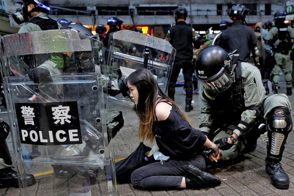 SEDIA DIBERKAS: Polis rusuhan menahan seorang penunjuk perasaan semasa perhimpunan antipemerintah di tengah Hongkong kelmarin. - Foto REUTERS