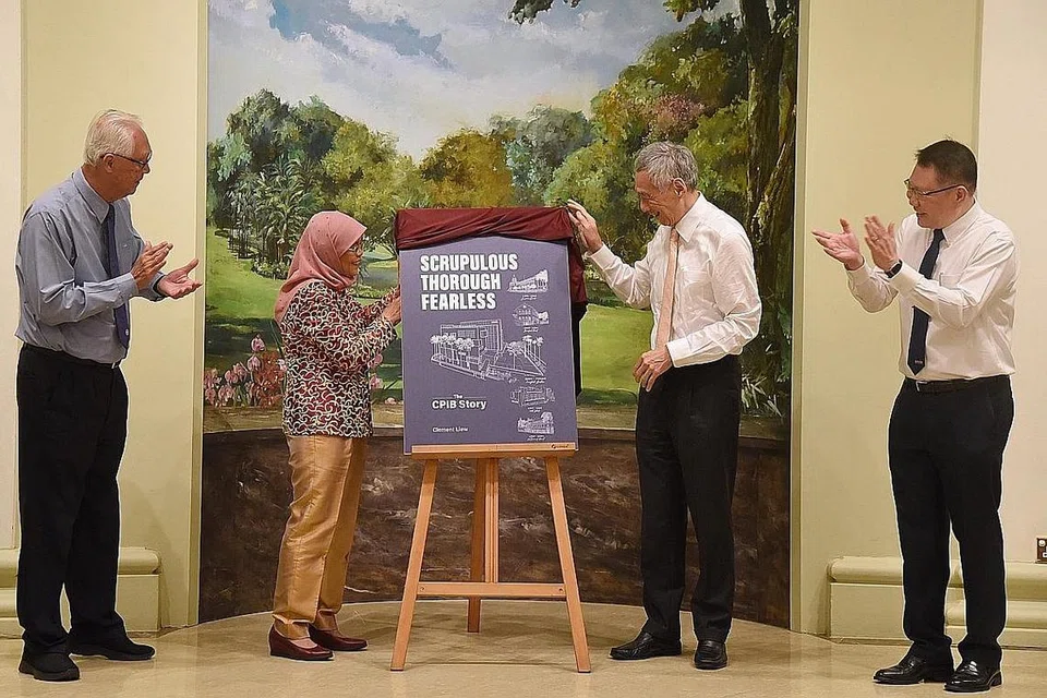 PELANCARAN BUKU SEJARAH CPIB: Sempena ulangtahun ke-70 CPIB, buku yang merakam sejarah biro itu sejak penubuhannya, telah dilancarkan oleh Presiden Halimah Yacob, Rabu lalu, di Istana. Pelancaran disaksikan oleh Perdana Menteri, Encik Lee Hsien Loong (dua dari kanan), dan Menteri Kanan Emiritus, Encik Goh Chok Tong (kiri) serta Pengarah CPIB, Encik Denis Tang (kanan). - Foto-foto BH oleh DESMOND WEE 