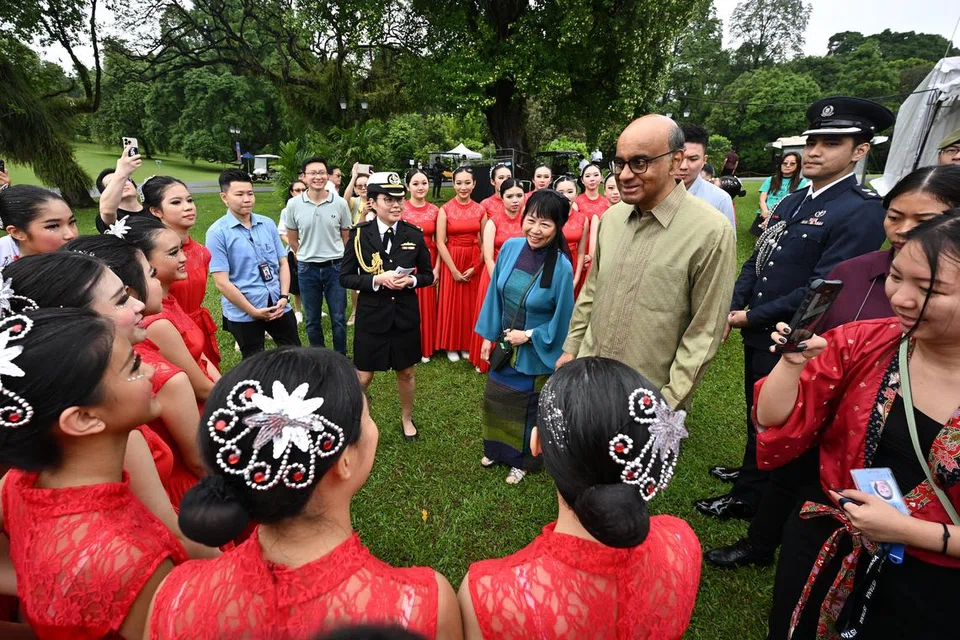 Presiden Tharman Shanmugaratnam (berkemeja hijau) dan isterinya, Puan Jane Ittogi (dua dari kanan) bertemu dan beramah mesra dengan sekumpulan penari dari Sekolah Menengah Tampines di pekarangan Istana.