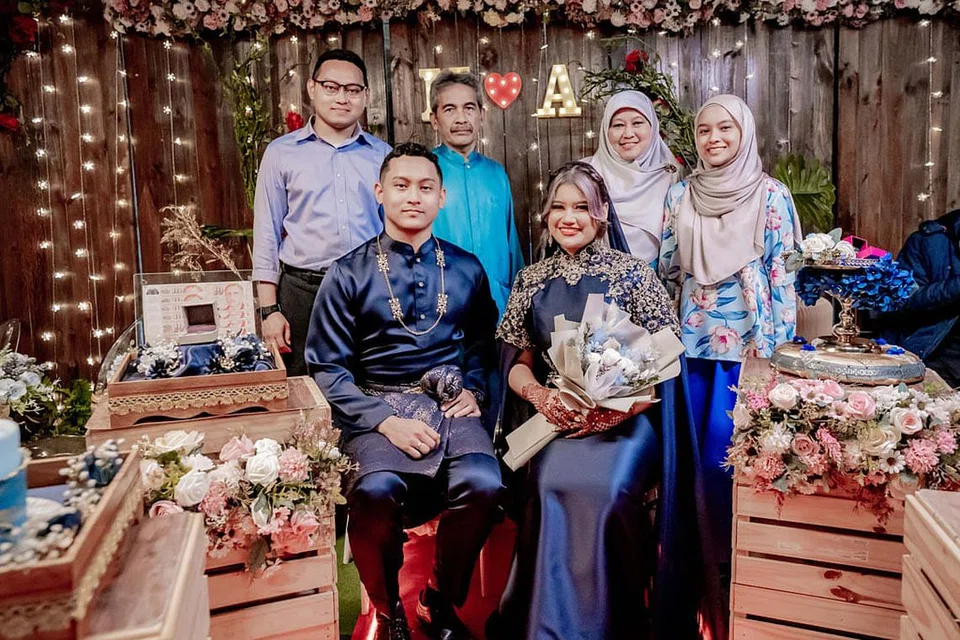 HARI BAHAGIA: Afrah Athasha (duduk di kanan) gembira melangkah ke fasa pertunangan bersama jejaka pilihan, Muhammad Muazzin (duduk di kiri). Bersama mereka keluarga Muazzin.