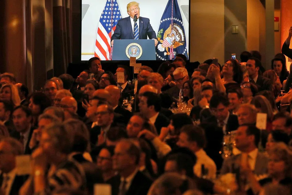 MINTA SOKONGAN ANGGOTA REPUBLIKAN: Anggota Republikan mendengar ucapan Presiden Trump di jamuan di Jawatankuasa Kongres Republikan Kebangsaan di Washington semalam. Encik Trump sedang cuba menarik sokongan Republikan bagi menolak Obamacare. - Foto REUTERS