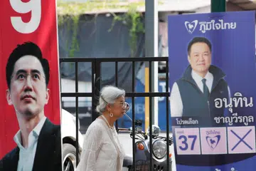 Seorang wanita Thailand berjalan di sebelah poster kempen pilihan raya calon perdana menteri Parti Pheu Thai, Yodchanan Wongsawat (kiri), serta Perdana Menteri Thailand dan pemimpin Parti Bhumjaithai, Anutin Charnvirakul (kanan), di Bangkok, Thailand, pada 4 Februari 2026. Suruhanjaya Pilihan Raya memaklumkan seramai 52.9 juta rakyat Thailand layak mengundi dalam pilihan raya pada 8 Februari. Thailand dijadual mengadakan pilihan raya umum pada tarikh yang sama dengan referendum bagi mengundi pindaan perlembagaan. 