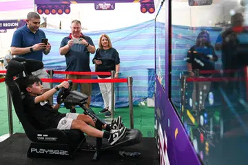 Seorang kanak-kanak bermain simulator kereta lumba di pesta bertemakan F1, Pesta Litar Glam, di Kampong Gelam, pada 18 September 2024. 