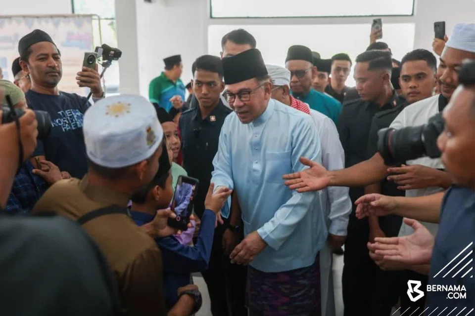 Perdana Menteri Malaysia, Datuk Seri Anwar Ibrahim (tengah), beramah mesra dengan anggota jemaah sebelum menunaikan solat Jumaat di Masjid Bandar Teknologi Kajang, Selangor, pada 19 April.