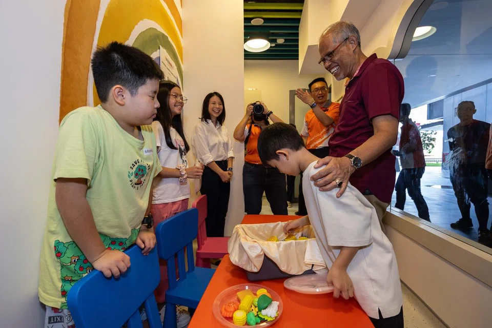 Menteri Pembangunan Sosial dan Keluarga merangkap Menteri Kedua Kesihatan, Encik Masagos Zulkifli Masagos Mohamad (kanan), berinteraksi dengan kanak-kanak di Family Nexus @ Our Tampines Hub pada 14 Jun 2024.