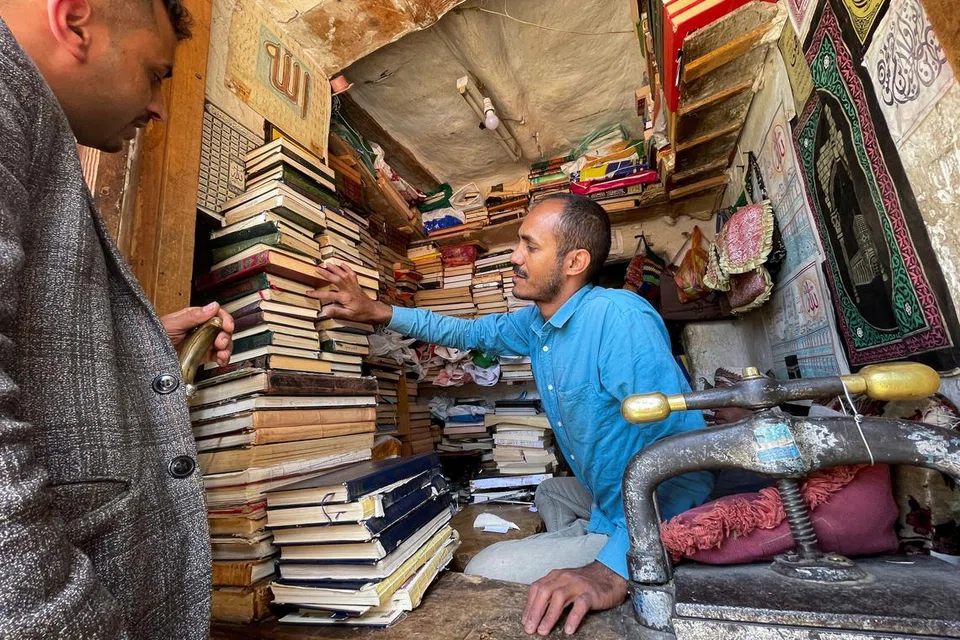 Bookbinder Hashim al-Seraji counts copies of the Koran he received from a customer as people send their Koran copies to traditional bookbinders for restoration ahead of and during the fasting month of Ramadan, in Sanaa, Yemen March 22, 2023. - Photo Reuters