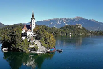 MENDAMAIKAN: Pemandangn Tasik Bled sunguh menakjubkan dengan airnya hijau kebiru-biruan berlatarkan banjaran gunung Julian Alps yang diselubungi salji. Di sebuah pulau kecil di tengah-tengah tasik berdiri Gereja Assumption. - Foto PROFESOR MADYA MOHAMAD ROSMAN OTHMAN
