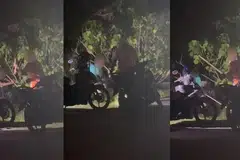 ANIAYA BINATANG: Rakaman video menunjukkan dua lelaki menyerang sesuatu menggunakan kayu di dalam semak.