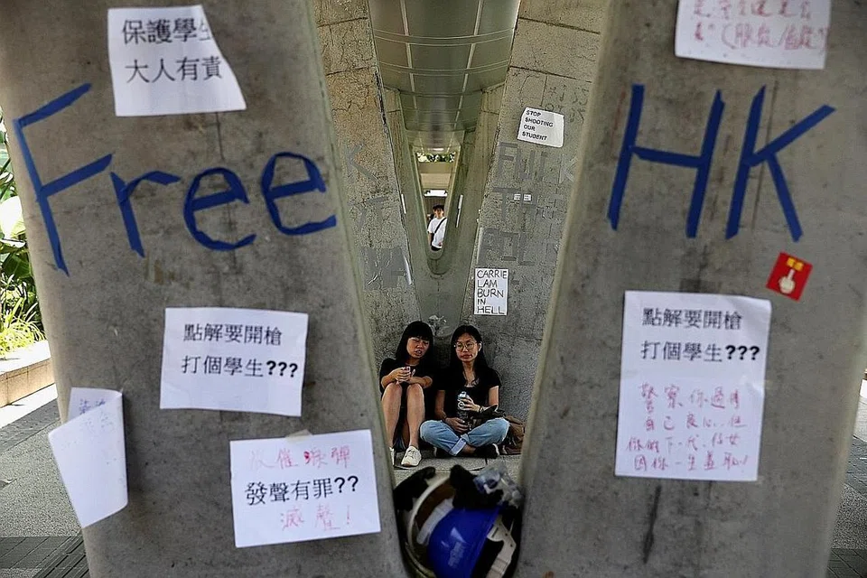 KEPENATAN: Warga duduk 'bertemankan' pelekat semalam dalam usaha membantah di Hongkong. - Foto REUTERS