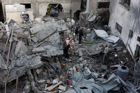 Para penduduk Palestin meninjau kerosakan selepas serangan udara Israel di Tengah Jaluran Gaza pada 23 November 2025.