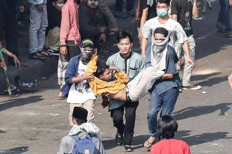 CEDERA: Perusuh Indonesia membawa rakan mereka yang cedera dalam pertempuran dengan pegawai polis semasa tunjuk perasaan di luar bangunan Badan Pengawas Pemilihan Umum Indonesia (Bawaslu) di Jakarta, Indonesia menyusuli keputusan pilihan raya presiden Indonesia kelmarin. - Foto EPA-EFE