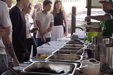 Peniaga nasi lemak yang membuat ramai bangga kerana pertuturannya berbahasa Inggeris dengan lancar dan perkhidmatan yang baik terhadap pelancong.