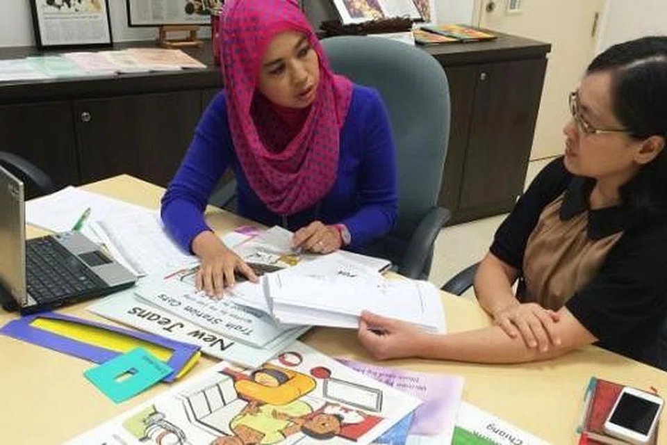 BUKU CERITA: Dr Elizabeth Pang (kanan) berbincang dengan Cik Azlina tentang pelbagai cara menarik minat membaca di kalangan kanak-kanak prasekolah. - Foto-foto HAIRIANTO DIMAN
