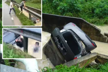 DETIK CEMAS: Keadaan kereta dinaiki dua wanita selepas dihanyutkan arus deras sejurus terbabas ke longkang. (Gambar sisipan) Seorang awam selamatkan mangsa.