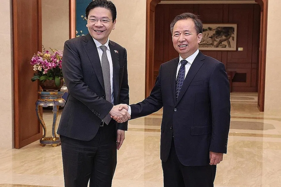 ANTARA DITEMUI: Encik Lawrence Wong (kiri) antara lain telah bertemu dengan Menteri Jabatan Pertubuhan Pusat Parti Komunis China (CPC), Encik Li Ganjie. - Foto-foto LAWRENCE WONG/ FACEBOOK