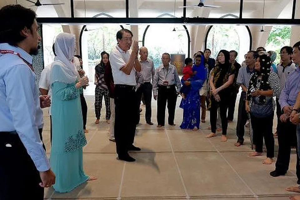 ERATKAN HUBUNGAN: Berucap kepada peserta kunjungan ke Masjid Al-Islah semalam, Encik Teo (tiga dari kiri) berharap masyarakat Singapura kekal bersepadu. Turut hadir ialah Cik Sun Xueling (dua dari kiri). - Foto TUKIMAN WARJI