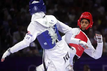 Atlet taekwondo Arab Saudi, Dunya Ali M Abutaleb (kanan) tewas kepada atlet Iran, Mobina Nematzadeh (ves biru) di perlawanan saringan semula untuk pingat gangsa Sukan Olimpik Taekwondo pada 7 Ogos. 