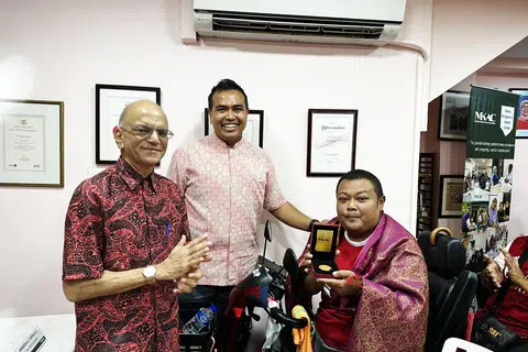BANTU PESAKIT GINJAL LAIN: Encik Mohd Kamsani AB Hamed (kanan), menerima Anugerah Ketabahan MKAC daripada Anggota Parlimen (AP) Pasir Ris–Punggol, Encik Sharael Taha (tengah), dan Presiden Kehormat MKAC, Encik Ameerali Abdeali (kiri), atas sumbangnnya mengedarkan makanan dan menjadi sumber inspirasi buat pesakit ginjal lain.
