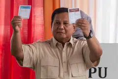 Presiden Indonesia, Encik Prabowo Subianto, menunjukkan kertas undi ketika datang mengundi pada pilihan raya wilayah di Bogor, Jawa Barat, pada 27 November.