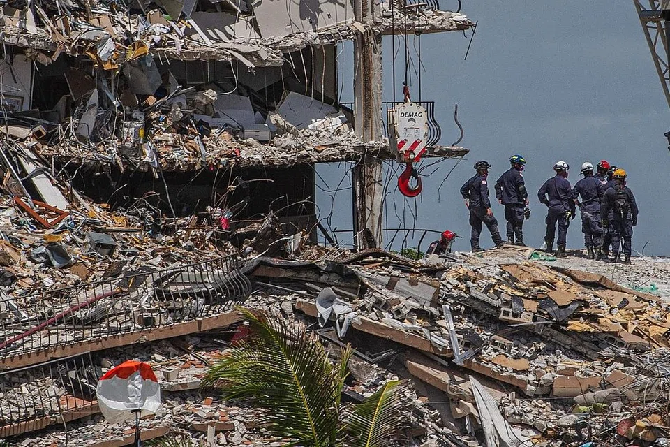 USAHA CARI MANGSA DITERUSKAN: Pasukan mencari dan menyelamat berusaha mencari mangsa yang mungkin terselamat menyusuli kejadian bangunan Champlain Towers South di Surfside, Florida, yang runtuh. - Foto AFP