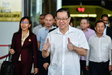 Pengerusi Parti Tindakan Demokratik (DAP), Encik Lim Guan Eng (tengah) pernah berkhidmat sebagai  setiausaha agung parti itu dari Mei 2004 hingga Mac 2022.