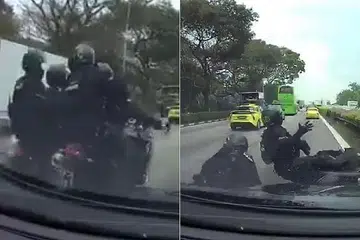 NAHAS DI TENGAH JALAN: Dua motosikal yang ditunggang anggota Pasukan Kerahan Pantas saling menggesel satu sama lain sebelum terjatuh di Ekspreswe Rentas Pulau. - Foto FACEBOOK/SHAIFUL APEK